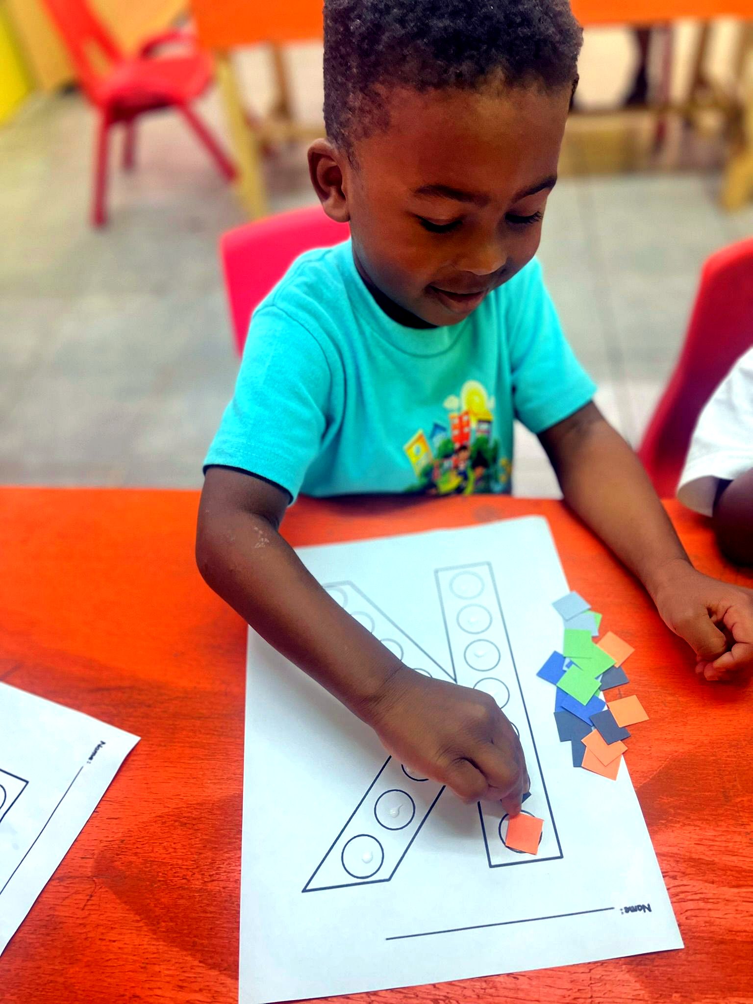 Infant and toddler program student doing a craft activity